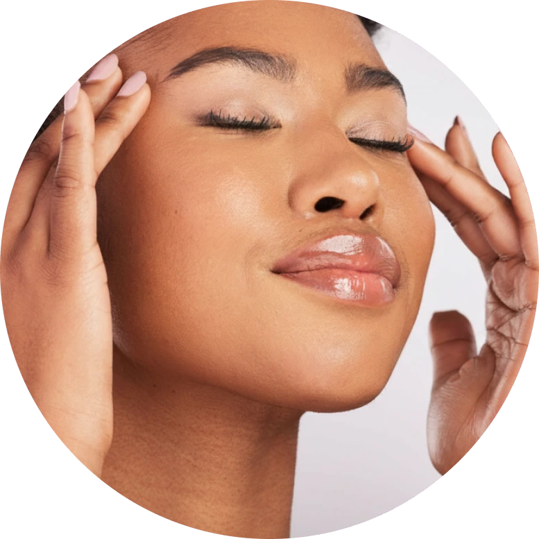 Woman touching her face with eyes closed and hands framing cheeks