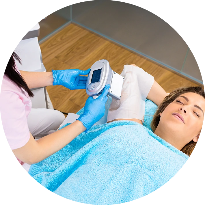 Aesthetician applying handheld radiofrequency device to patient's face during facial treatment